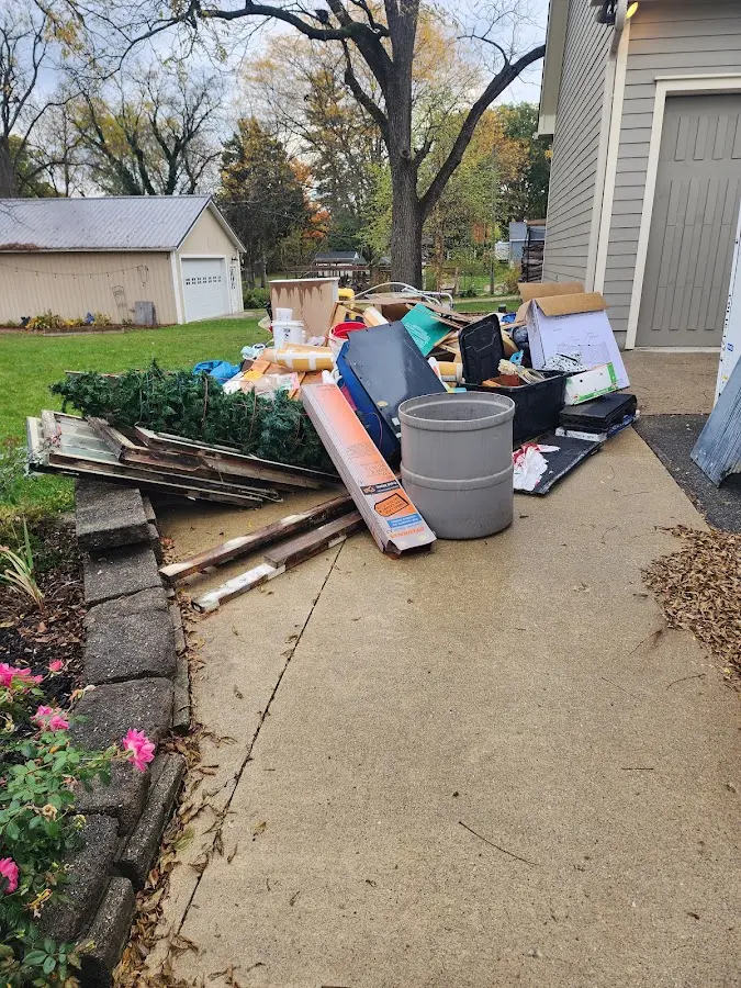 Dumpster being loaded with debris for Estate Cleanout Dumpster Rental in Jordan